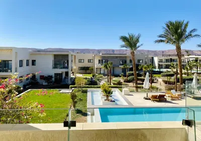 a resort with a swimming pool and palm trees at Cozy Studio Apt @ G-cribs El Gouna with a View. in Hurghada