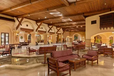 a lobby with chairs and tables in a building at Pickalbatros Sands Port Ghalib in Port Ghalib