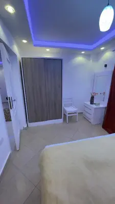 a room with a blue ceiling with a door and a bench at Palma house apartments A8 in Hurghada