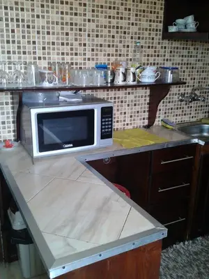 a microwave sitting on a counter in a kitchen at Sun & Fun in Quseir