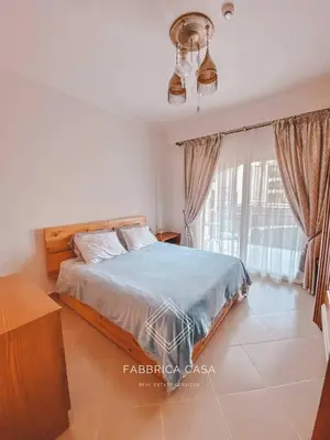 a bedroom with a bed and a large window at Beautiful 1 bedroom apartment in Quseir