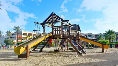 a playground with a slide on the beach at Bliss Nada Beach Resort in Coraya Bay