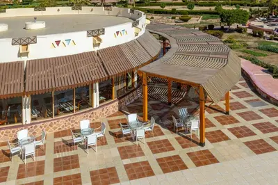 an overhead view of a patio with chairs and a building at Bliss Nada Beach Resort in Coraya Bay