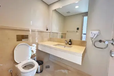 a bathroom with a toilet and a sink at Homestyle 3BR Penthouse Pool & Beach View in Hurghada