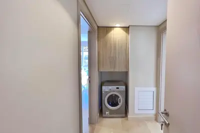 a laundry room with a washing machine in a hallway at Homestyle 3BR Penthouse Pool & Beach View in Hurghada
