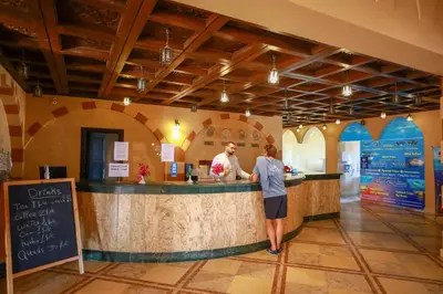 two people standing at a bar in a restaurant at Marina view port ghalib in Port Ghalib