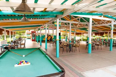a pool table on a patio with tables and chairs at Sentido Caribbean World Soma Bay in Hurghada