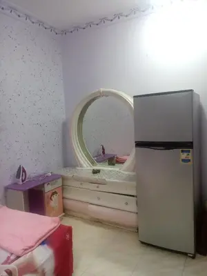 a small room with a mirror and a refrigerator at Yasin - Enjoy the privacy of staying in a quiet apartment with free Wi-Fi as your complete second home in the heart of Hurghada in Hurghada