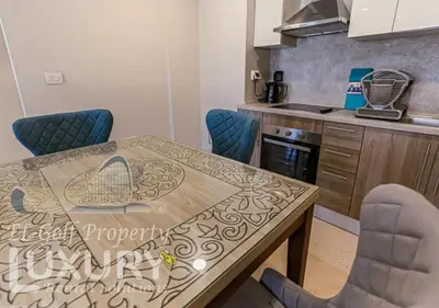 a kitchen with a dining table and chairs at Mangarov-2BR. M1-6b-12 in Hurghada
