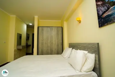 a bedroom with a large bed with white pillows at Florenza khamsin home Hurghada in Hurghada