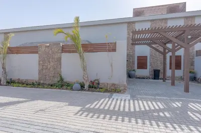 a building with palm trees in front of it at Modern 1 Bedroom Apartment Bali El Gouna Private Patio & Heated Pool in Hurghada