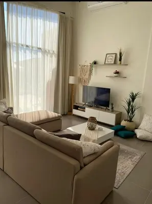a living room with a couch and a tv at Somabay BW Villa - families only in Hurghada