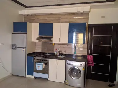 a kitchen with a refrigerator and a washing machine at Casablanca resort in Hurghada
