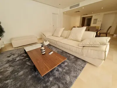 a living room with a couch and a coffee table at Ollystays Mangroovy Seaview 3BR Beach and Pool Free access in Hurghada
