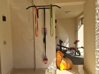 a room with two ski poles and a bike at Ollystays Mangroovy Seaview 3BR Beach and Pool Free access in Hurghada