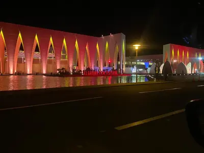 a building at night with red and yellow lights at Lovely two bedroom apartment in Hurghada