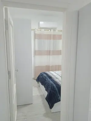 a bedroom with a bed in a white room at Aqua Palms Resort by Ivan C408 in Hurghada