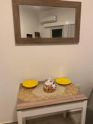 a table with two yellow plates and a mirror at Aqua Palms Resort by Ivan C408 in Hurghada