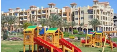 a playground in front of a large building at VIVA Andalouse luxury family suite, private beach & pool, NO ORFI in Hurghada