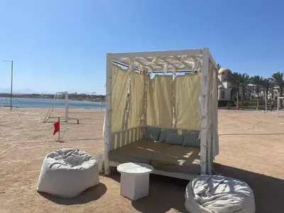 a bed in a tent on the beach at Apartman Veranda in Hurghada