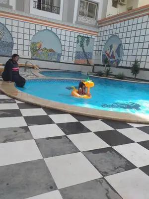 a couple of people playing in a swimming pool at sheraton blaza329 in Hurghada
