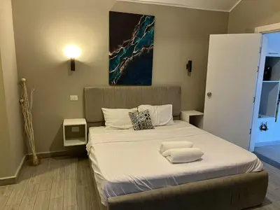 a bedroom with a bed with two towels on it at 2BR Twin House With Private Heated Pool at El-Gouna -Seperate 1Bedroom & Seperate Guest studio- in Hurghada