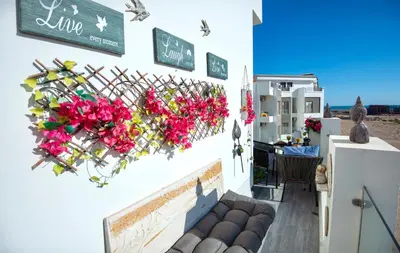 a white building with flowers on a wall at Luxury 95m Penthouse - Boutique Resort & Wifi in Hurghada
