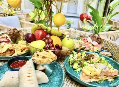 a table with plates of food on it at Luxury 95m Penthouse - Boutique Resort & Wifi in Hurghada
