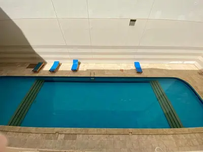 a row of blue benches in a pool at Чудесная студия в комплексе с бассейном рядом с бесплатным пляжем in Hurghada