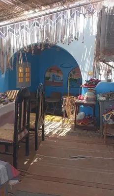 a room with two chairs and a table in a room at Aziza House in Aswan