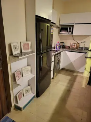 a kitchen with a refrigerator and a dishwasher at Central location Aqua Tropical Resort Al Gouna RD 401 in Hurghada