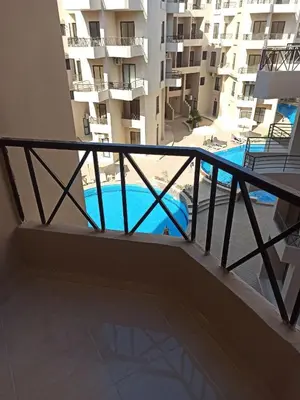 a balcony with a view of a swimming pool at Central location Aqua Tropical Resort Al Gouna RD 401 in Hurghada