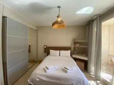 a bedroom with a bed with two towels on it at Mangroovy Gouna 1 BR apartment in Hurghada