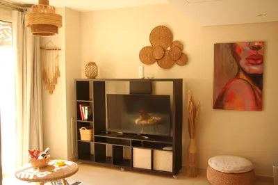 a living room with a flat screen tv in a living room at Mangroovy Gouna 1 BR apartment in Hurghada