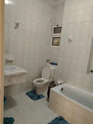 a bathroom with a toilet and a tub and a sink at Paradise Hill Compound in Hurghada