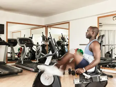 a man sitting on a treadmill in a gym at Club Paradisio El Gouna Red Sea in Hurghada