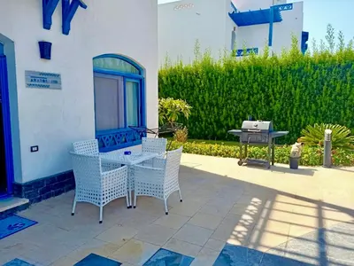 a patio with a table and chairs and a grill at Luxury 8BR Villa with seaview and private pool in Hurghada in Hurghada