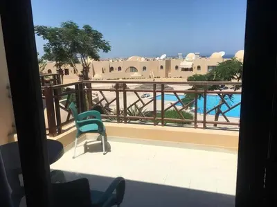 a room with a balcony with a view of a pool at Pool view one bedroom - B203 in Hurghada