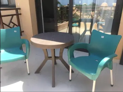 two chairs and a table and a table and chairs at Pool view one bedroom - B203 in Hurghada