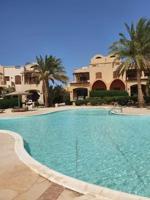 a large swimming pool in front of a building at Sabina 2br penthouse in Hurghada