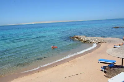 a person in the water on a beach at La Casa Beach in Hurghada