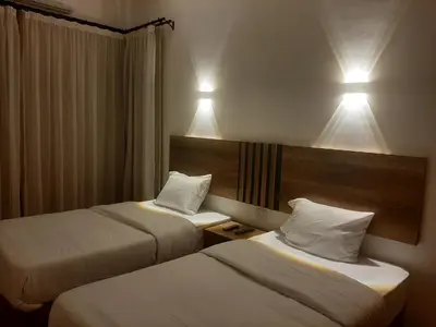 a hotel room with two beds and two lights at La Casa Beach in Hurghada