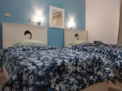 a bedroom with two beds with blue walls at Jasmine villa in Hurghada