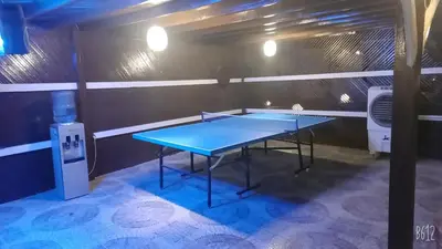 a ping pong table in a room with a machine at Dolphin Continental Hotel in Quseir