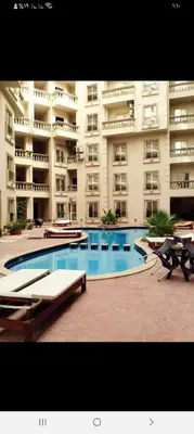 a large apartment building with a large swimming pool at Cleopatra Resort F16 in Hurghada