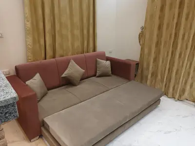 a brown couch with pillows in a living room at Cleopatra Resort F16 in Hurghada