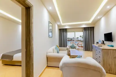 a hotel room with a bed and a living room at Sunrise Alma Bay Resort in Hurghada