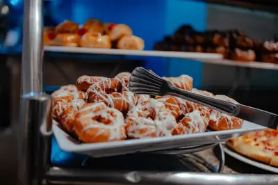 a tray of donuts with a fork and a spatula at Royal Star Beach Resort in Hurghada