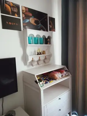 a room with a white desk with shelves and a tv at G-Cribs gouna in Hurghada