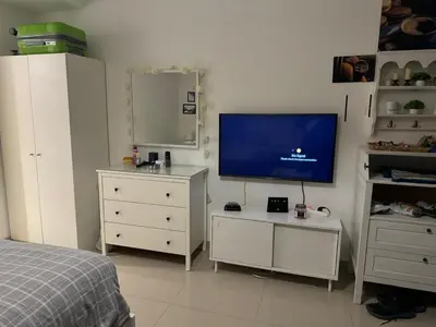 a bedroom with a bed and a flat screen tv at G-Cribs gouna in Hurghada